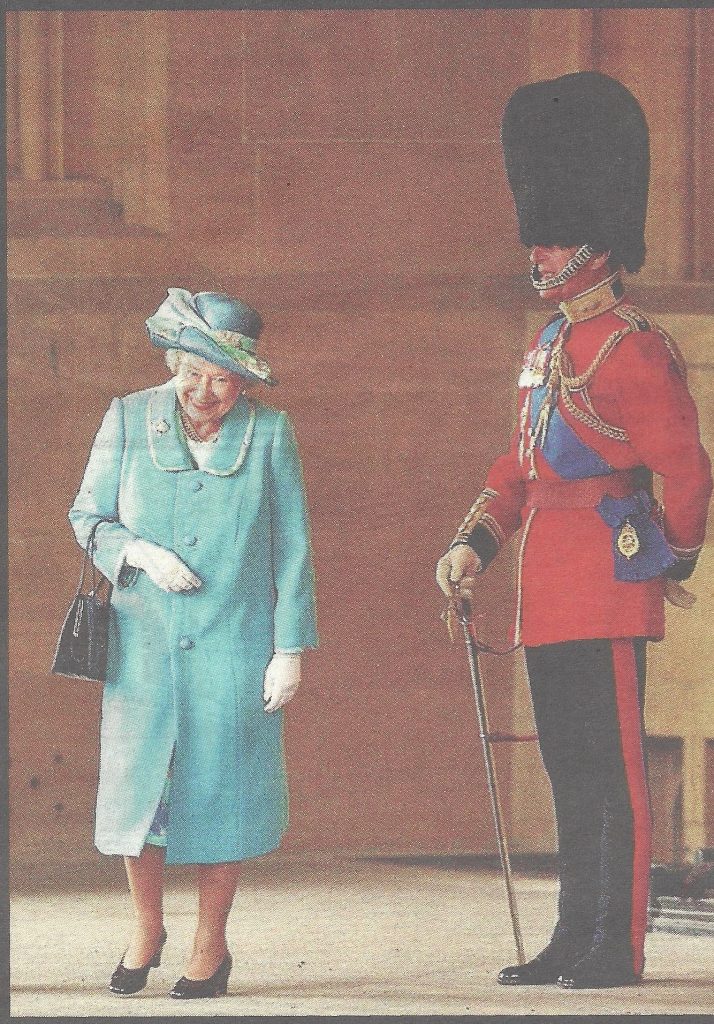 The Queen walks past her husband, giggling, as he is dressed in his uniform as Colonel of the Grenadier Guards 2003